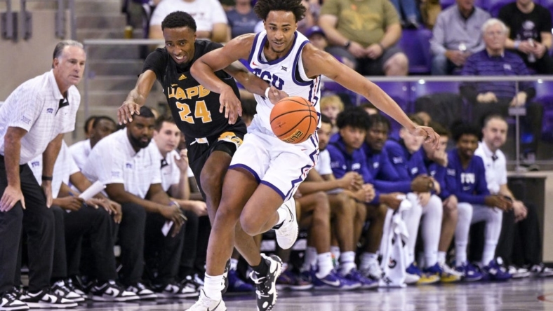 Nov 7, 2022; Fort Worth, Texas, USA; Arkansas-Pine Bluff Golden Lions guard AC Curry (24) and TCU Horned Frogs forward Chuck O'Bannon Jr. (5) in action during the game between the TCU Horned Frogs and the Arkansas-Pine Bluff Golden Lions at Ed and Rae Schollmaier Arena. Mandatory Credit: Jerome Miron-USA TODAY Sports