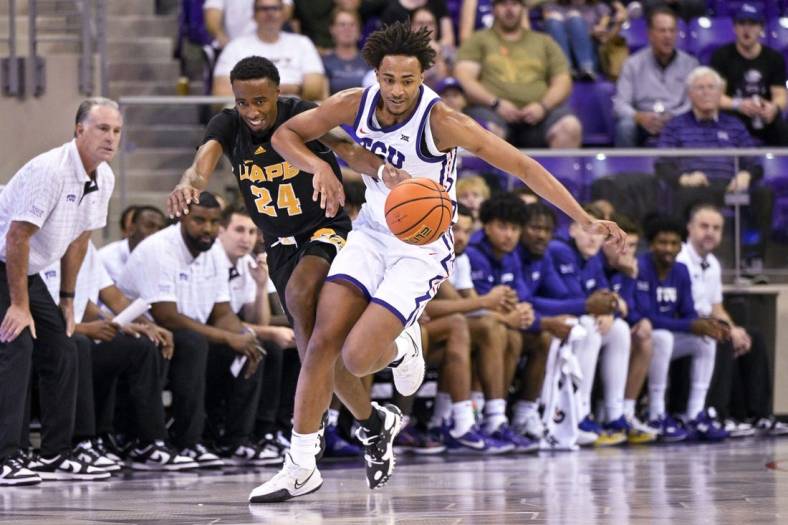 Nov 7, 2022; Fort Worth, Texas, USA; Arkansas-Pine Bluff Golden Lions guard AC Curry (24) and TCU Horned Frogs forward Chuck O'Bannon Jr. (5) in action during the game between the TCU Horned Frogs and the Arkansas-Pine Bluff Golden Lions at Ed and Rae Schollmaier Arena. Mandatory Credit: Jerome Miron-USA TODAY Sports