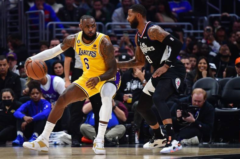 Nov 9, 2022; Los Angeles, California, USA; Los Angeles Lakers forward LeBron James (6) moves the ball against Los Angeles Clippers forward Marcus Morris Sr. (8) during the second half at Crypto.com Arena. Mandatory Credit: Gary A. Vasquez-USA TODAY Sports