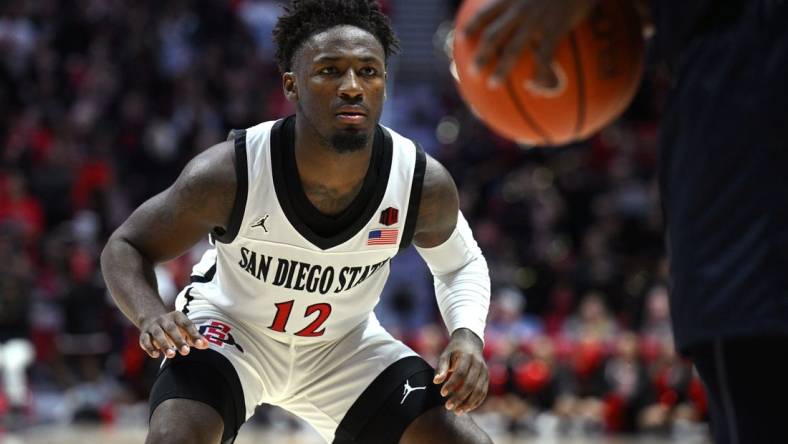 Nov 7, 2022; San Diego, California, USA; San Diego State Aztecs guard Darrion Trammell (12) defends during the second half against the Cal State Fullerton Titans at Viejas Arena. Mandatory Credit: Orlando Ramirez-USA TODAY Sports