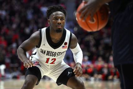 Nov 7, 2022; San Diego, California, USA; San Diego State Aztecs guard Darrion Trammell (12) defends during the second half against the Cal State Fullerton Titans at Viejas Arena. Mandatory Credit: Orlando Ramirez-USA TODAY Sports