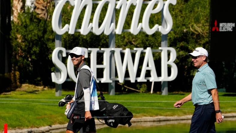 Nov 10, 2022; Phoenix, AZ, USA; John Huston (right) walks off the 18th hole smiling after shooting 6-under-par during round one of the Charles Schwab Cup at Phoenix Country Club. Mandatory Credit: Rob Schumacher-USA TODAY Sports