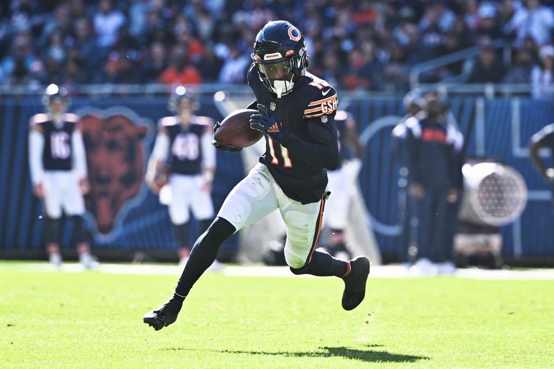 Nov 6, 2022; Chicago, Illinois, USA;  Chicago Bears wide receiver Darnell Mooney (11) controls the ball against the Miami Dolphins at Soldier Field. Mandatory Credit: Jamie Sabau-USA TODAY Sports