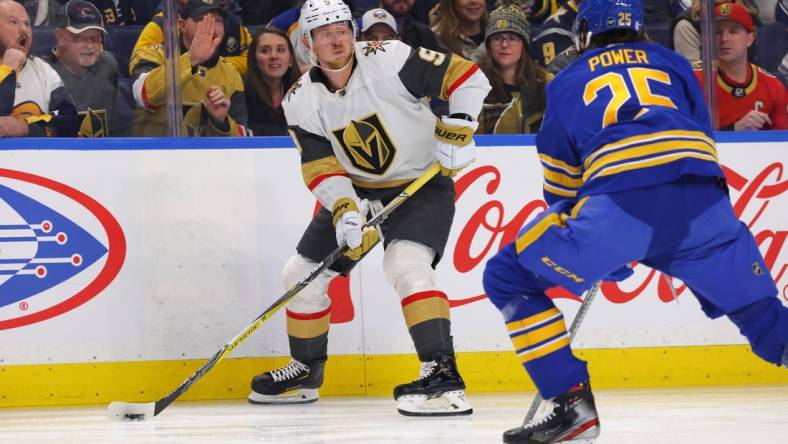 Nov 10, 2022; Buffalo, New York, USA;  Vegas Golden Knights center Jack Eichel (9) looks to make a pass as Buffalo Sabres defenseman Owen Power (25) defends during the first period at KeyBank Center. Mandatory Credit: Timothy T. Ludwig-USA TODAY Sports