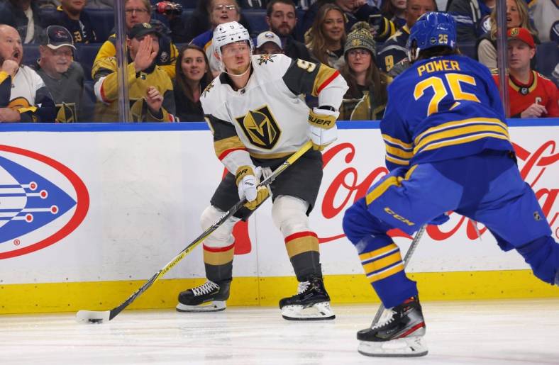 Nov 10, 2022; Buffalo, New York, USA;  Vegas Golden Knights center Jack Eichel (9) looks to make a pass as Buffalo Sabres defenseman Owen Power (25) defends during the first period at KeyBank Center. Mandatory Credit: Timothy T. Ludwig-USA TODAY Sports