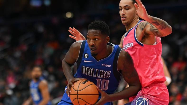 Nov 10, 2022; Washington, District of Columbia, USA;  Dallas Mavericks forward Dorian Finney-Smith (10) looks to pass as Washington Wizards forward Kyle Kuzma (33) defends during the first half at Capital One Arena. Mandatory Credit: Tommy Gilligan-USA TODAY Sports