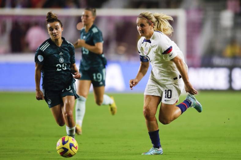 Nov 10, 2022; Ft. Lauderdale, Florida, USA; United States midfielder Lindsey Horan (10) runs with the ball ahead of Germany midfielder Lina Magull (20) during the first half at DRV PNK Stadium. Mandatory Credit: Sam Navarro-USA TODAY Sports