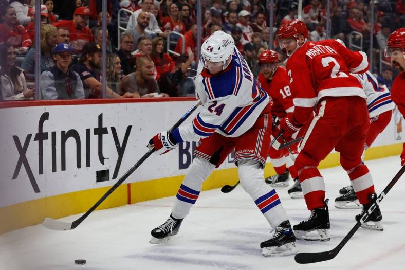 Nov 10, 2022; Detroit, Michigan, USA; New York Rangers right wing Kaapo Kakko (24) and Detroit Red Wings defenseman Olli Maatta (2) battle for the puck in the first period at Little Caesars Arena. Mandatory Credit: Rick Osentoski-USA TODAY Sports