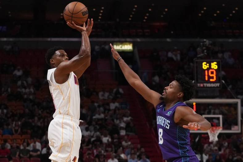 Nov 10, 2022; Miami, Florida, USA; Miami Heat guard Kyle Lowry (7) attempts to shoot the ball over Charlotte Hornets guard Dennis Smith Jr. (8) during the first half at FTX Arena. Mandatory Credit: Jasen Vinlove-USA TODAY Sports
