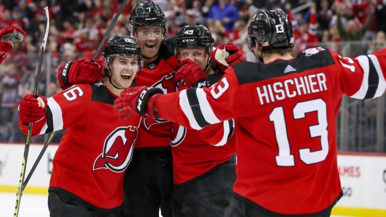 Nov 10, 2022; Newark, New Jersey, USA; (Editors Notes: Caption Correction) New Jersey Devils center Nico Hischier (13) celebrates with center Jack Hughes (86), defenseman Dougie Hamilton (7), and left wing Fabian Zetterlund (49) after scoring the game winning goal in overtime against the Ottawa Senators at Prudential Center. Mandatory Credit: Tom Horak-USA TODAY Sports