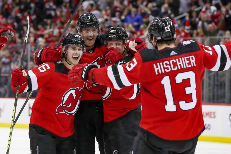 Nov 10, 2022; Newark, New Jersey, USA; (Editors Notes: Caption Correction) New Jersey Devils center Nico Hischier (13) celebrates with center Jack Hughes (86), defenseman Dougie Hamilton (7), and left wing Fabian Zetterlund (49) after scoring the game winning goal in overtime against the Ottawa Senators at Prudential Center. Mandatory Credit: Tom Horak-USA TODAY Sports