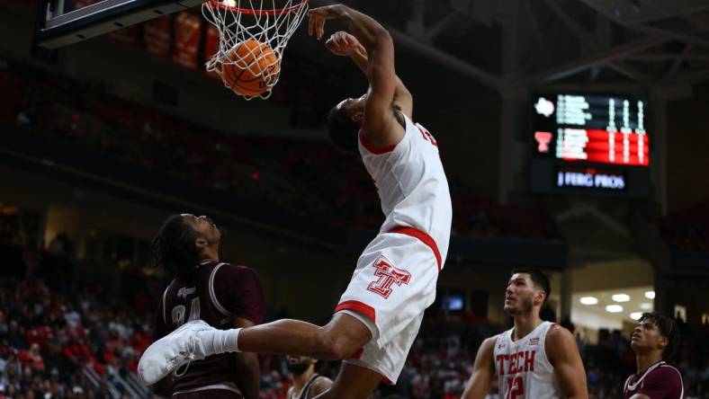 Nov 10, 2022; Lubbock, Texas, USA; Texas Tech Red Raiders forward Kevin Obanor (0) does a reverse dunk against Texas Southern Tigers forward John Walker III (24) in the second half at United Supermarkets Arena. Mandatory Credit: Michael C. Johnson-USA TODAY Sports