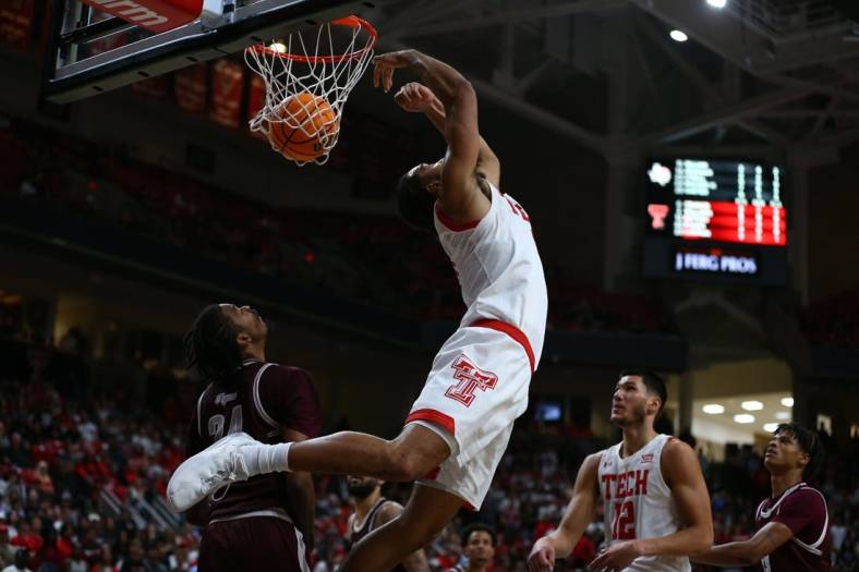 Nov 10, 2022; Lubbock, Texas, USA; Texas Tech Red Raiders forward Kevin Obanor (0) does a reverse dunk against Texas Southern Tigers forward John Walker III (24) in the second half at United Supermarkets Arena. Mandatory Credit: Michael C. Johnson-USA TODAY Sports