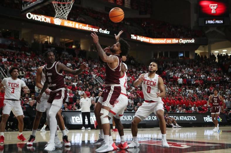 Nov 10, 2022; Lubbock, Texas, USA; Texas Southern Tigers forward Grayson Carter (25) goes after a loose ball in front of Texas Tech Red Raiders guard De   Vion Harmon (23) in the first half at United Supermarkets Arena. Mandatory Credit: Michael C. Johnson-USA TODAY Sports