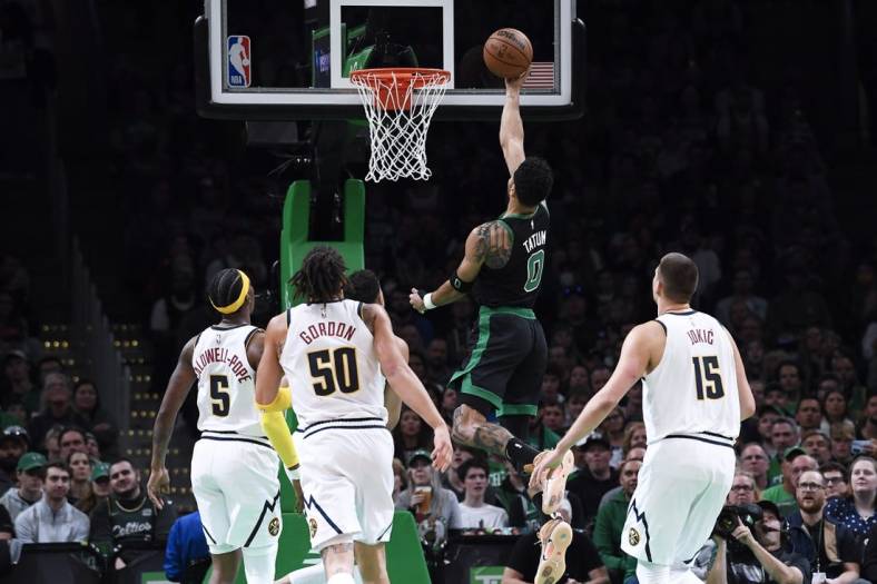 Nov 11, 2022; Boston, Massachusetts, USA;  Boston Celtics forward Jayson Tatum (0) lays the ball in the basket during the first half against the Denver Nuggets at TD Garden. Mandatory Credit: Bob DeChiara-USA TODAY Sports