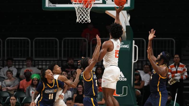 Nov 11, 2022; Coral Gables, Florida, USA; Miami Hurricanes forward Norchad Omier (15) shoots the ball against the UNC Greensboro Spartans during the first half at Watsco Center. Mandatory Credit: Jasen Vinlove-USA TODAY Sports