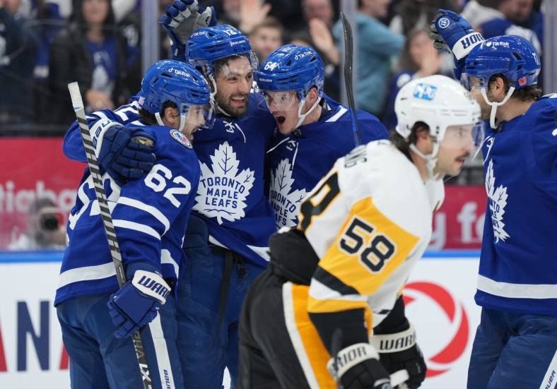 Nov 11, 2022; Toronto, Ontario, CAN;  Toronto Maple Leafs center Zach Aston-Reese (12) scores a goal and celebrates with Toronto Maple Leafs center Denis Malgin (62) and Toronto Maple Leafs center David Kampf (64) against the Pittsburgh Penguins during the first period at Scotiabank Arena. Mandatory Credit: Nick Turchiaro-USA TODAY Sports