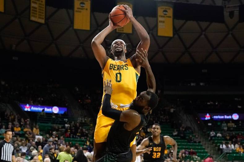 Nov 11, 2022; Waco, Texas, USA;  Baylor Bears forward Flo Thamba (0) scores a basket while being fouled by Norfolk State Spartans guard Joe Bryant Jr. (4) during the first half at Ferrell Center. Mandatory Credit: Chris Jones-USA TODAY Sports