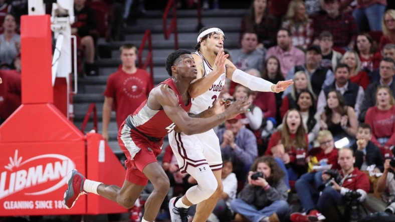 Nov 11, 2022; Fayetteville, Arkansas, USA; Arkansas Razorbacks guard Davonte Davis (4) and Fordham Rams guard Darius Quisenberry (3) reach for a loose ball in the first half at Bud Walton Arena. Mandatory Credit: Nelson Chenault-USA TODAY Sports