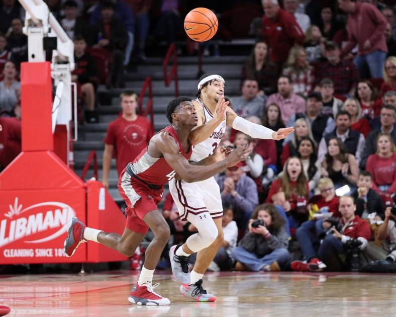 Nov 11, 2022; Fayetteville, Arkansas, USA; Arkansas Razorbacks guard Davonte Davis (4) and Fordham Rams guard Darius Quisenberry (3) reach for a loose ball in the first half at Bud Walton Arena. Mandatory Credit: Nelson Chenault-USA TODAY Sports