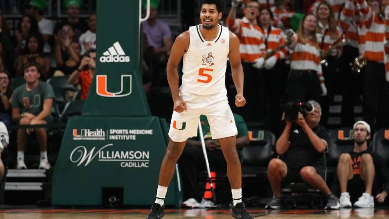 Nov 11, 2022; Coral Gables, Florida, USA; Miami Hurricanes guard Harlond Beverly (5) reacts after making a three point basket against the UNC Greensboro Spartans during the second half at Watsco Center. Mandatory Credit: Jasen Vinlove-USA TODAY Sports