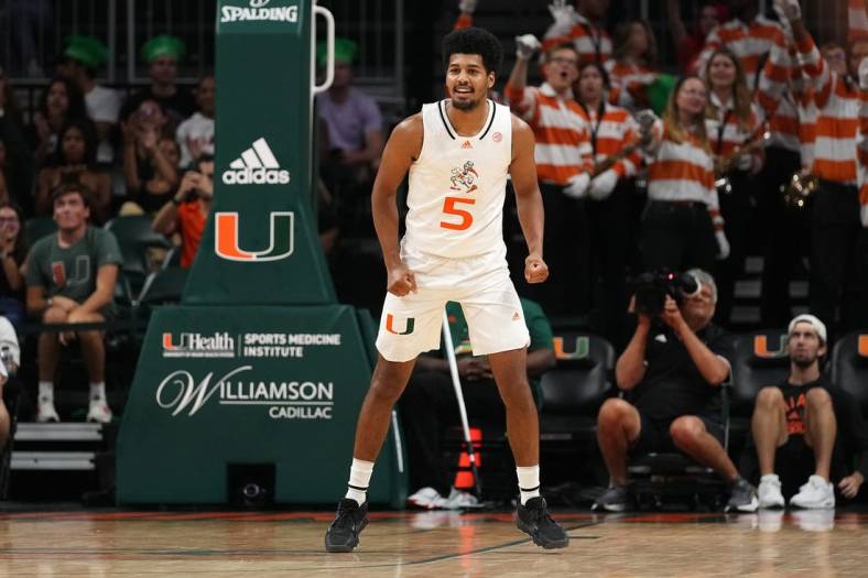 Nov 11, 2022; Coral Gables, Florida, USA; Miami Hurricanes guard Harlond Beverly (5) reacts after making a three point basket against the UNC Greensboro Spartans during the second half at Watsco Center. Mandatory Credit: Jasen Vinlove-USA TODAY Sports