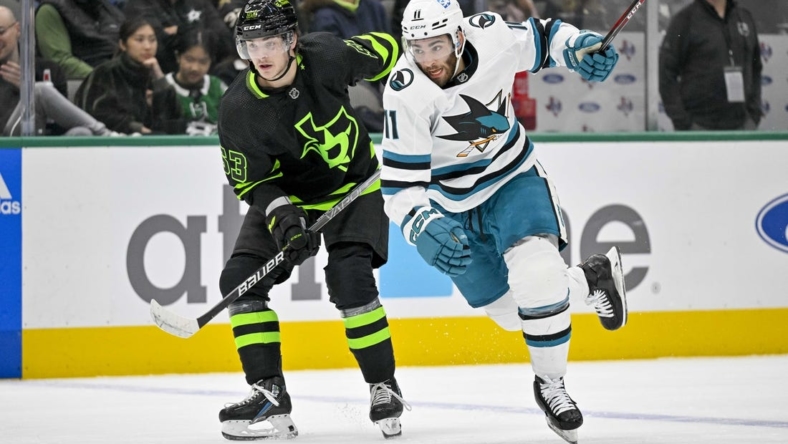 Nov 11, 2022; Dallas, Texas, USA; Dallas Stars center Wyatt Johnston (53) and San Jose Sharks center Luke Kunin (11) chase the puck during the first period at American Airlines Center. Mandatory Credit: Jerome Miron-USA TODAY Sports
