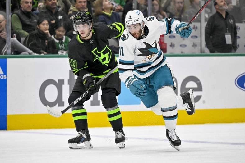 Nov 11, 2022; Dallas, Texas, USA; Dallas Stars center Wyatt Johnston (53) and San Jose Sharks center Luke Kunin (11) chase the puck during the first period at American Airlines Center. Mandatory Credit: Jerome Miron-USA TODAY Sports