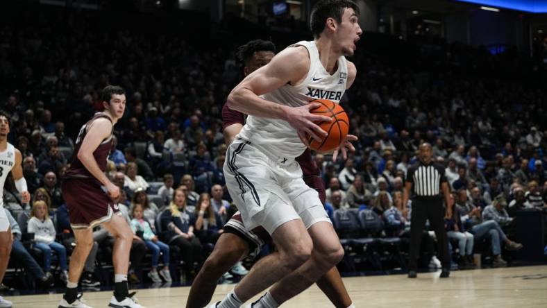 Xavier's Zach Freemantle recieves the ball under the hoop during the Xavier Musketeers vs. Montana Grizzlies game at the Cintas Center on Friday Nov. 11, 2022. The Musketeers lead the game 49-37 at halftime.