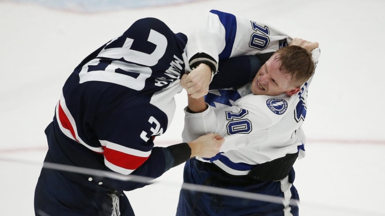 Nov 11, 2022; Washington, District of Columbia, USA; Tampa Bay Lightning right wing Corey Perry (10) exchanges words with Washington Capitals right wing Anthony Mantha (39) during the third period at Capital One Arena. Mandatory Credit: Amber Searls-USA TODAY Sports