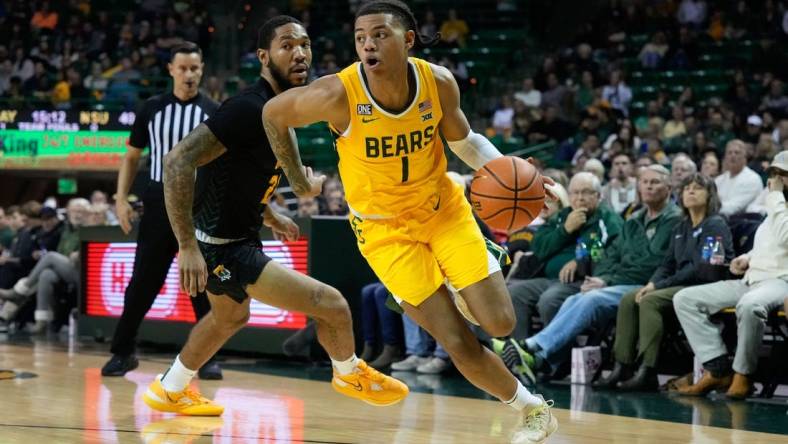 Nov 11, 2022; Waco, Texas, USA;  Baylor Bears guard Keyonte George (1) drives to the basket past Norfolk State Spartans forward Dana Tate Jr. (21) during the second half at Ferrell Center. Mandatory Credit: Chris Jones-USA TODAY Sports