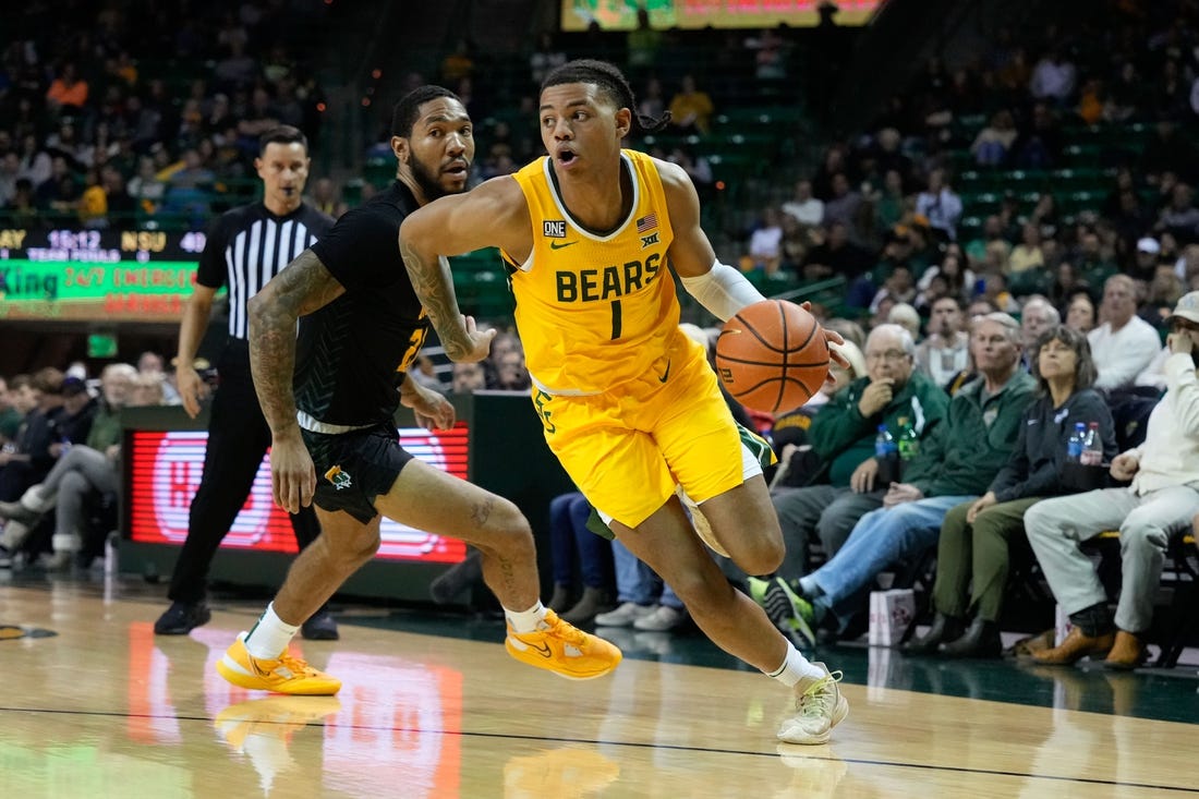 Nov 11, 2022; Waco, Texas, USA;  Baylor Bears guard Keyonte George (1) drives to the basket past Norfolk State Spartans forward Dana Tate Jr. (21) during the second half at Ferrell Center. Mandatory Credit: Chris Jones-USA TODAY Sports
