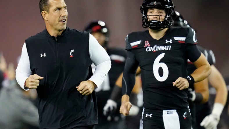 Cincinnati Bearcats head coach Luke Fickell and quarterback Ben Bryant (6) take the field for the first quarter of the NCAA American Athletic Conference game between the Cincinnati Bearcats and the East Carolina Pirates at Nippert Stadium in Cincinnati on Friday, Nov. 11, 2022.

East Carolina Pirates At Cincinnati Bearcats Football