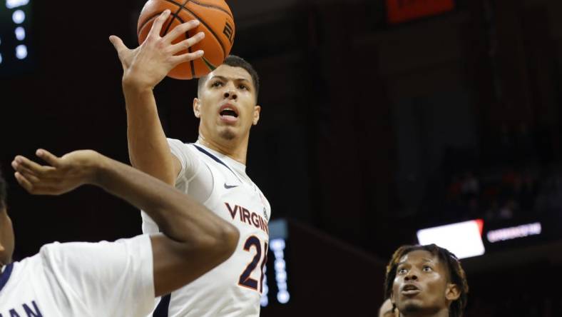 Nov 11, 2022; Charlottesville, Virginia, USA;  Virginia Cavaliers forward Kadin Shedrick (21) rebounds the ball in front of Monmouth Hawks forward Myles Foster (5) in the first halfat John Paul Jones Arena. Mandatory Credit: Geoff Burke-USA TODAY Sports