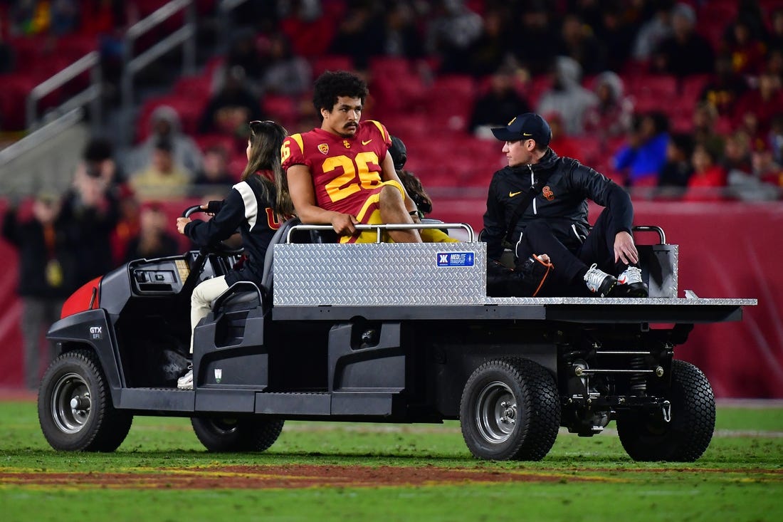 Nov 11, 2022; Los Angeles, California, USA; Southern California Trojans running back Travis Dye (26) is taken off the field after suffering an apparent injury against the Colorado Buffaloes during the first half at the Los Angeles Memorial Coliseum. Mandatory Credit: Gary A. Vasquez-USA TODAY Sports