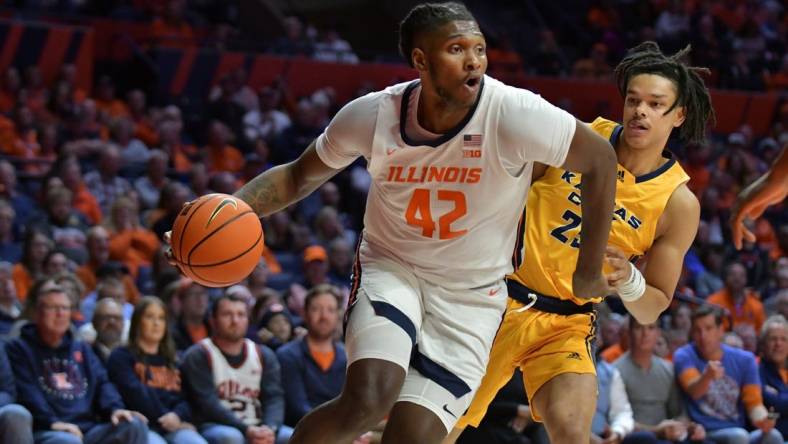 Nov 11, 2022; Champaign, Illinois, USA;  Illinois Fighting Illini forward Dain Dainja (42) drives the ball past UMKC Kangaroos guard Tyler Andrews (25) during the first half at State Farm Center. Mandatory Credit: Ron Johnson-USA TODAY Sports