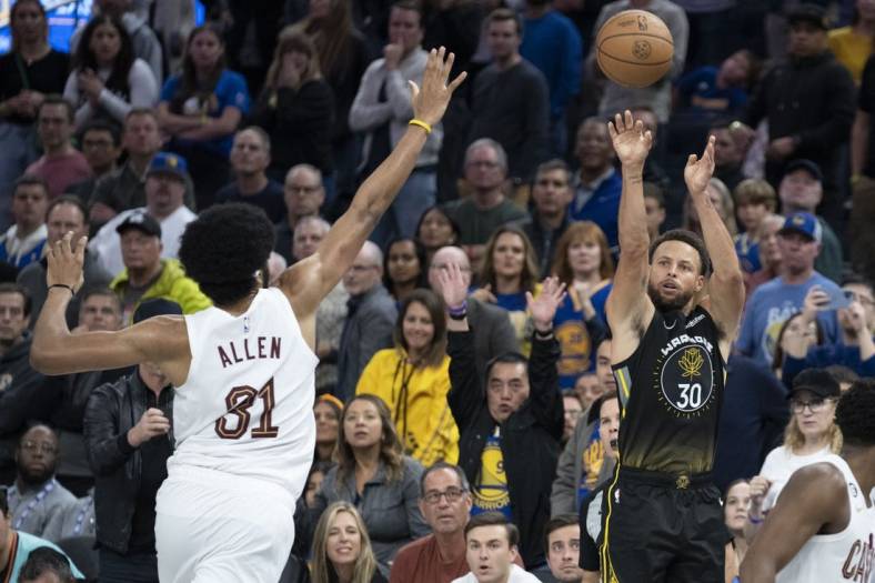 November 11, 2022; San Francisco, California, USA; Golden State Warriors guard Stephen Curry (30) shoots the basketball against Cleveland Cavaliers center Jarrett Allen (31) during the fourth quarter at Chase Center. Mandatory Credit: Kyle Terada-USA TODAY Sports