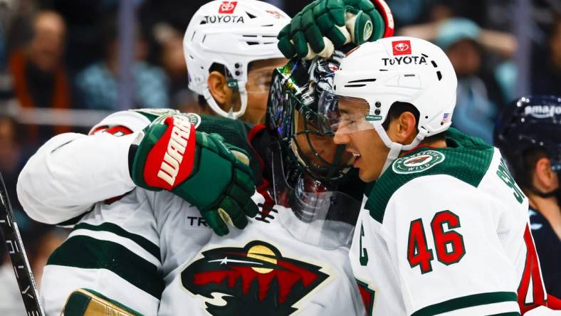 Nov 11, 2022; Seattle, Washington, USA; Minnesota Wild goaltender Marc-Andre Fleury (29) and defenseman Jared Spurgeon (46) celebrate following a 1-0 victory against the Seattle Kraken at Climate Pledge Arena. Mandatory Credit: Joe Nicholson-USA TODAY Sports