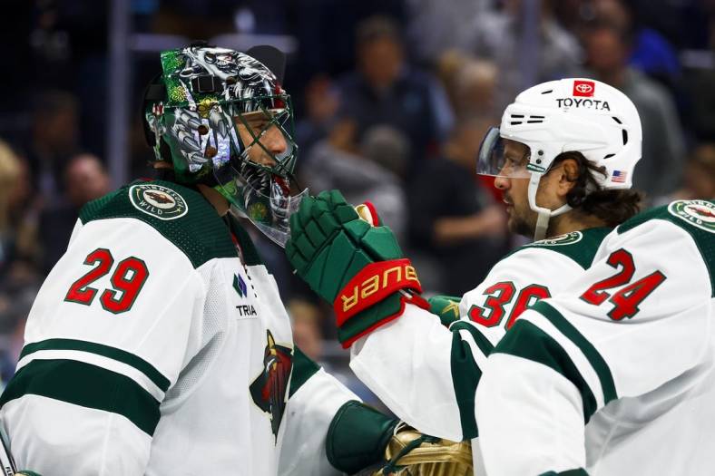 Nov 11, 2022; Seattle, Washington, USA; Minnesota Wild goaltender Marc-Andre Fleury (29) and right wing Mats Zuccarello (36) celebrate following a 1-0 victory against the Seattle Kraken at Climate Pledge Arena. Mandatory Credit: Joe Nicholson-USA TODAY Sports