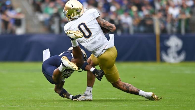 Nov 12, 2022; Baltimore, Maryland, USA;  Notre Dame Fighting Irish wide receiver Braden Lenzy (0) toss a Navy Midshipmen defender during the first quarter at M&T Bank Stadium. Mandatory Credit: Tommy Gilligan-USA TODAY Sports