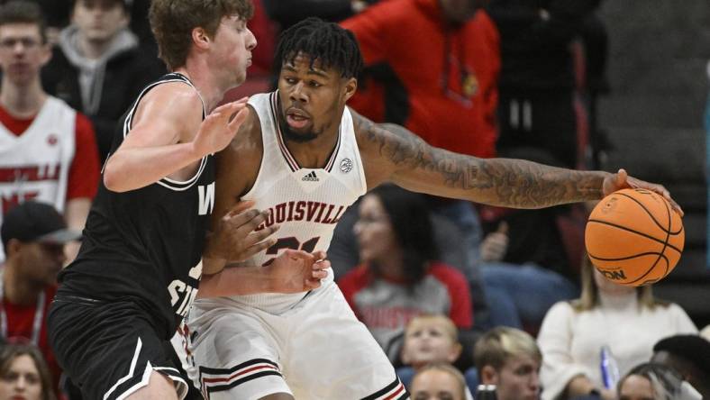 Nov 12, 2022; Louisville, Kentucky, USA;  Louisville Cardinals forward Sydney Curry (21) posts up against Wright State Raiders center AJ Braun (12) during the first half at KFC Yum! Center. Mandatory Credit: Jamie Rhodes-USA TODAY Sports