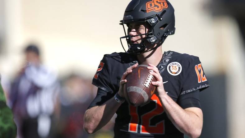 Nov 12, 2022; Stillwater, Oklahoma, USA; Oklahoma State's Gunnar Gundy (12) warms up before the college football game between the Oklahoma State Cowboys (OSU) and the Iowa State Cyclones at Boone Pickens Stadium. Mandatory Credit: Sarah Phipps/The Oklahoman-USA TODAY NETWORK