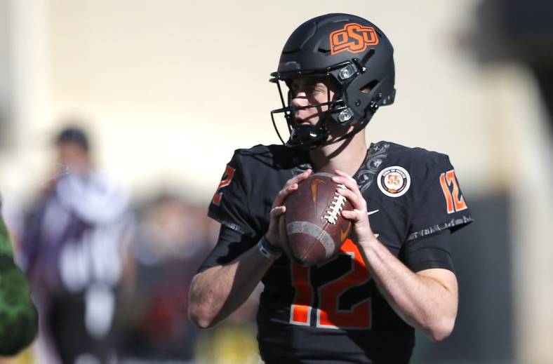 Nov 12, 2022; Stillwater, Oklahoma, USA; Oklahoma State's Gunnar Gundy (12) warms up before the college football game between the Oklahoma State Cowboys (OSU) and the Iowa State Cyclones at Boone Pickens Stadium. Mandatory Credit: Sarah Phipps/The Oklahoman-USA TODAY NETWORK