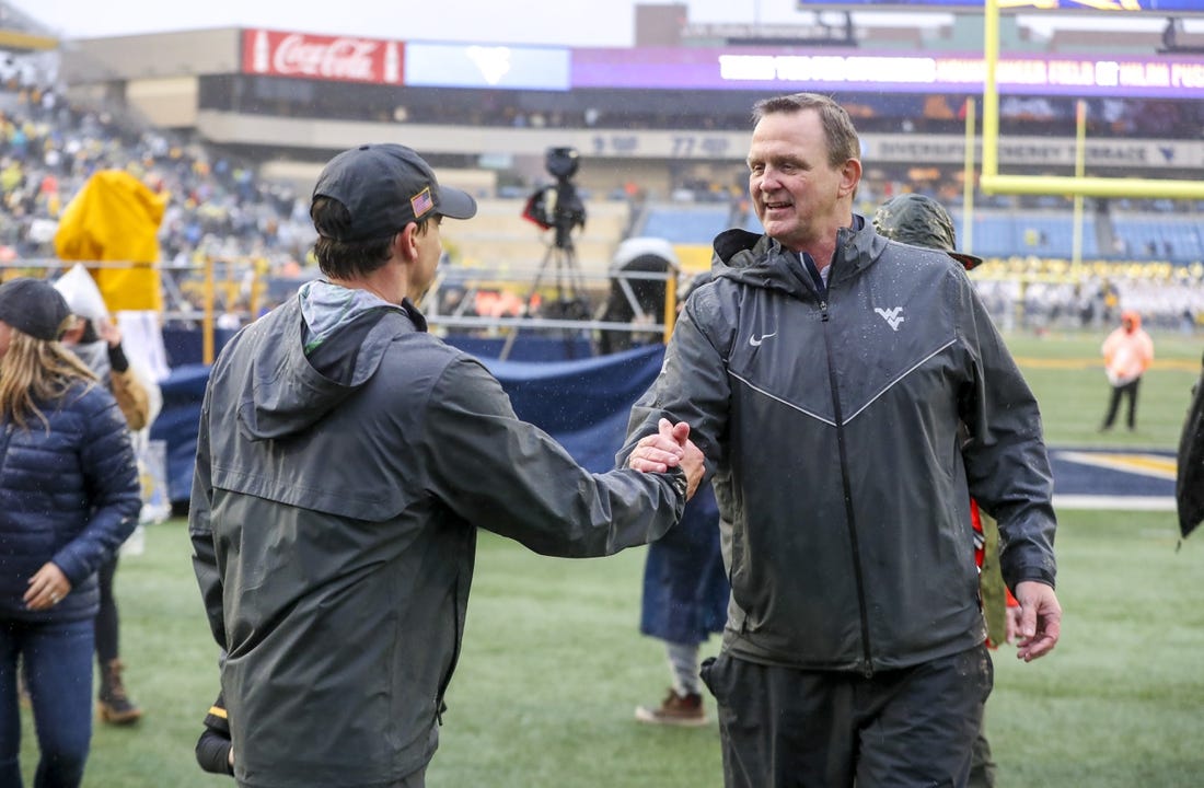 Nov 12, 2022; Morgantown, West Virginia, USA; West Virginia Mountaineers athletic director Shane Lyons celebrates with West Virginia Mountaineers head coach Neal Brown after defeating the Oklahoma Sooners at Mountaineer Field at Milan Puskar Stadium. Mandatory Credit: Ben Queen-USA TODAY Sports