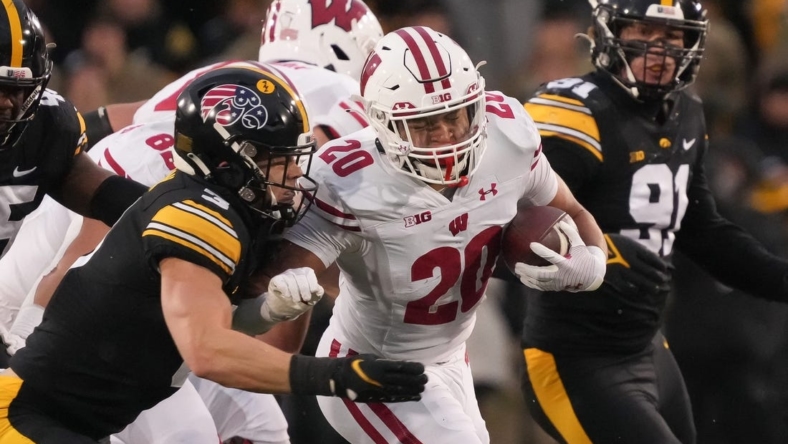 Iowa defensive back Cooper DeJean, left, tackles Wisconsin running back Isaac Guerendo in the second quarter during a NCAA college football game in Iowa City on Saturday, Nov. 12, 2022.

Iowavswisconsin 20221112 Bh