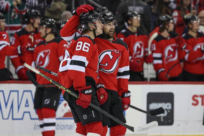 Nov 12, 2022; Newark, New Jersey, USA; New Jersey Devils center Jack Hughes (86) and left wing Tomas Tatar (90) look up at the main scoreboard after a goal against the Arizona Coyotes during the first period at Prudential Center. Mandatory Credit: Vincent Carchietta-USA TODAY Sports