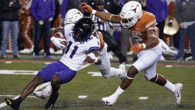 Nov 12, 2022; Austin, Texas, USA; Texas Longhorns linebacker Diamonte Tucker-Dorsey (2) tackles Texas Christian Horned Frogs kick returner Derius Davis (11) during the opening kickoff at Darrell K Royal-Texas Memorial Stadium. Mandatory Credit: Scott Wachter-USA TODAY Sports