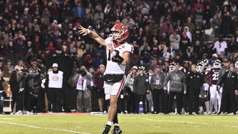 Nov 12, 2022; Starkville, Mississippi, USA; Georgia Bulldogs quarterback Stetson Bennett (13) throws a pass against the Mississippi State Bulldogs that would result in a touchdown during the first quarter at Davis Wade Stadium at Scott Field. Mandatory Credit: Matt Bush-USA TODAY Sports