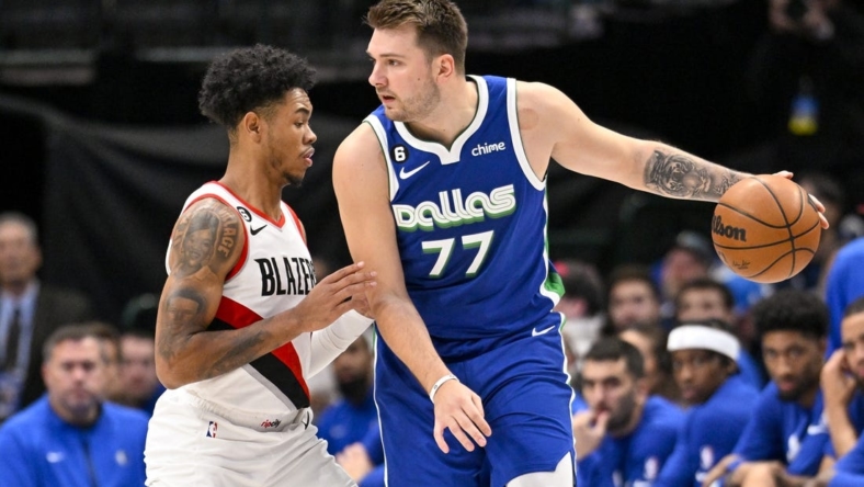 Nov 12, 2022; Dallas, Texas, USA; Portland Trail Blazers guard Anfernee Simons (1) guards Dallas Mavericks guard Luka Doncic (77) during the first quarter at the American Airlines Center. Mandatory Credit: Jerome Miron-USA TODAY Sports