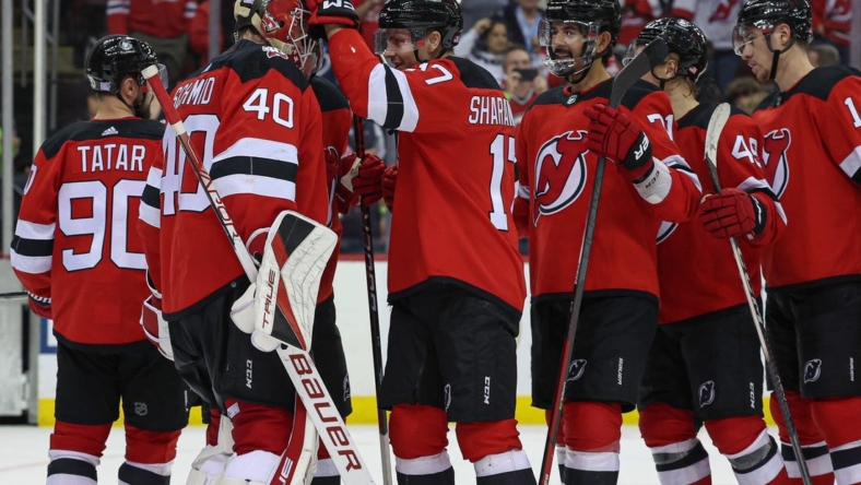 Nov 12, 2022; Newark, New Jersey, USA; New Jersey Devils goaltender Akira Schmid (40) celebrates with teammates after defeating the Arizona Coyotes at Prudential Center. Mandatory Credit: Vincent Carchietta-USA TODAY Sports